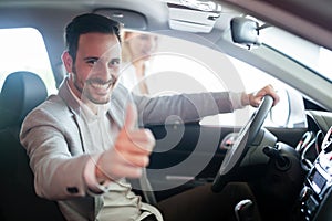 Portrait of happy customer buying new car