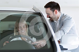 Portrait of happy customer buying new car