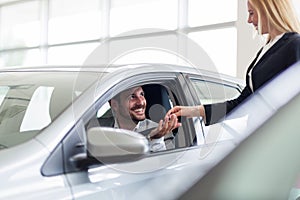 Portrait of happy customer buying new car