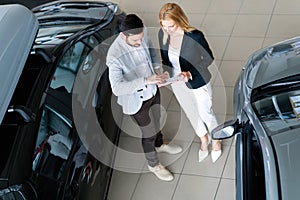 Portrait of happy customer buying new car