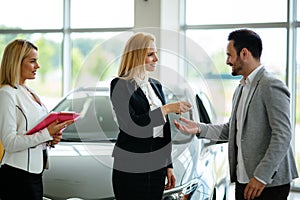 Portrait of happy customer buying new car