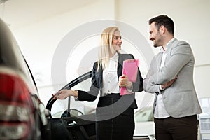 Portrait of happy customer buying new car