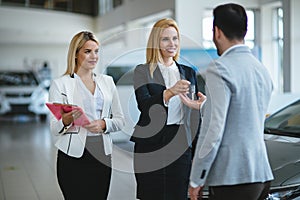 Portrait of happy customer buying new car