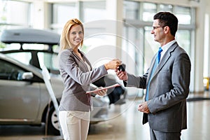 Portrait of happy customer buying new car