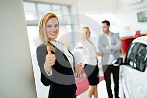 Portrait of happy customer buying new car