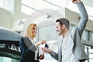 Portrait of happy customer buying new car