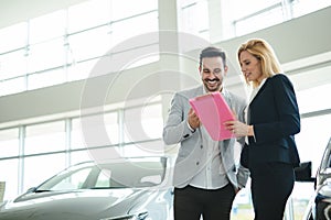 Portrait of happy customer buying new car