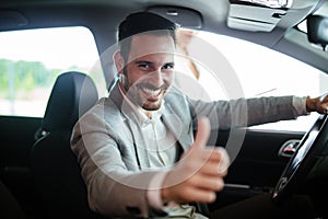 Portrait of happy customer buying new car