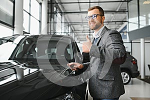 Portrait of happy customer buying new car.