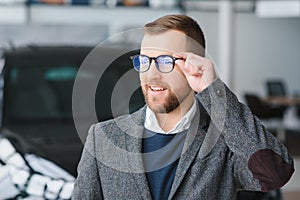 Portrait of happy customer buying new car.