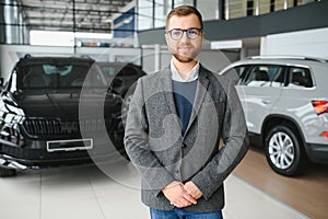 Portrait of happy customer buying new car.