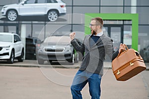 Portrait of happy customer buying new car.