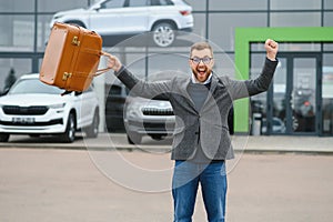 Portrait of happy customer buying new car.