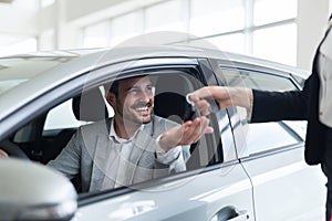 Portrait of happy customer buying new car photo