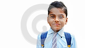 Portrait of happy cute little indian boy in school uniform looking at camera. Child education concept. Rural india