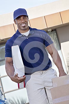 Portrait of a happy delivery man carrying packages