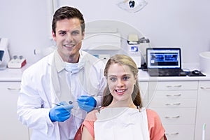 Portrait of happy dentist and female patient