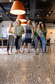 Portrait of happy diverse female colleagues in casual meeting in office lunchroom, copy space