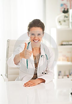 Portrait of happy doctor woman showing thumbs up