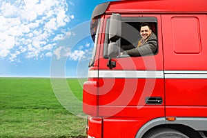 Portrait of happy driver in cab of truck