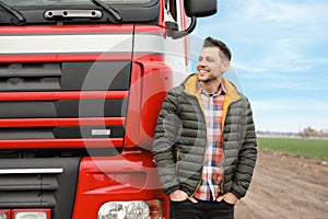 Portrait of happy driver at modern truck outdoors