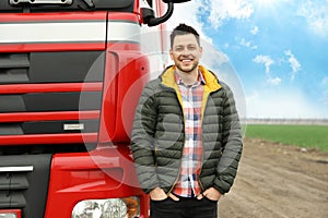 Portrait of happy driver at modern truck outdoors