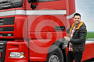 Portrait of happy driver opening door of modern truck