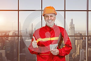 Portrait of happy elder man holding money and showing like gesture.