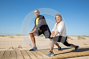 Portrait of happy elderly couple doing workout together