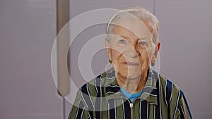 Portrait of happy elderly woman smiling, looking at camera, retired senior woman