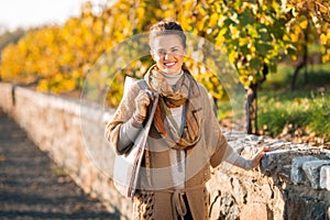 Portrait of happy elegant brunette woman in autumn park