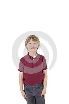 Portrait of happy elementary boy in school uniform over white background