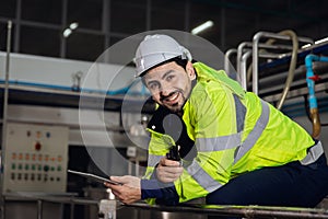 portrait happy engineer factory worker foreman supervisor working in heavy industry sitting relax smiling looking camera