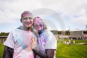 Portrait of a happy European couple celebrating Holi