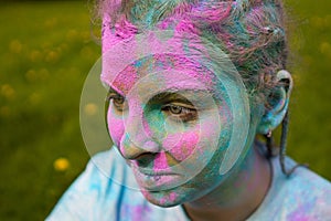 Portrait of happy European woman celebrating Holi with powder colors or gulal.