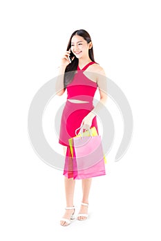 portrait of a happy excited asian woman in red dress standing ta