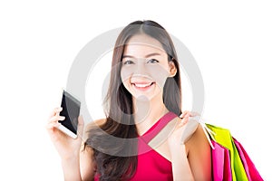 Portrait of a happy excited asian woman in red dress standing talking phone