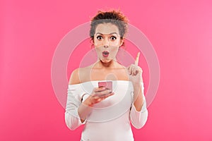 Portrait of a happy excited girl holding mobile phone