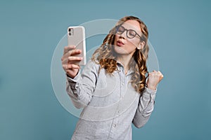 Portrait of a happy excited girl holding mobile phone