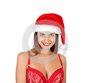 Portrait of happy excited pretty smiling girl in christmas hat and swimsuit. emotional woman in red santa claus hat isolated on wh