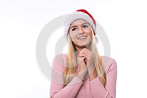 Portrait of happy excited pretty woman in santa hat on white background