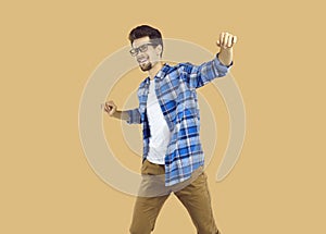 Portrait of happy excited young man dancing celebrating success