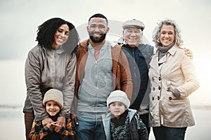 Portrait, happy and extended family or excited people bonding spending quality time together on holiday. Beach, winter