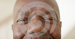 Portrait of happy eyes of african american senior man at home, slow motion