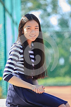 portrait happy face of asian girl toothy smiling happiness emotion in outdoor sport field