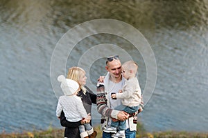 Portrait of a happy family against the background lake