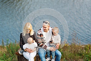 Portrait of a happy family against the background lake