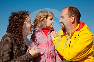 Portrait of happy family against blue sky