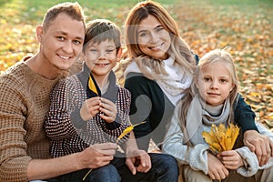 Portrait of happy family in autumn park