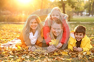 Portrait of happy family in autumn park